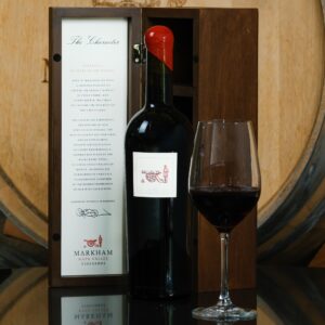 Bottle of the Character next to glass of wine and wooden box
