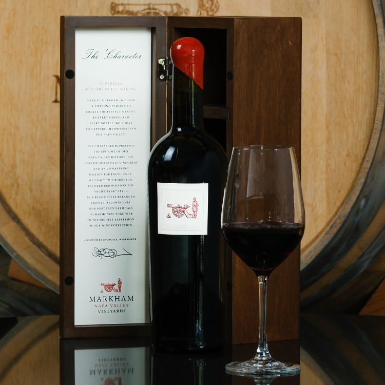 Bottle of the Character next to glass of wine and wooden box