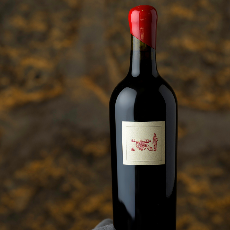 Bottle of the Character next to glass of wine and wooden box
