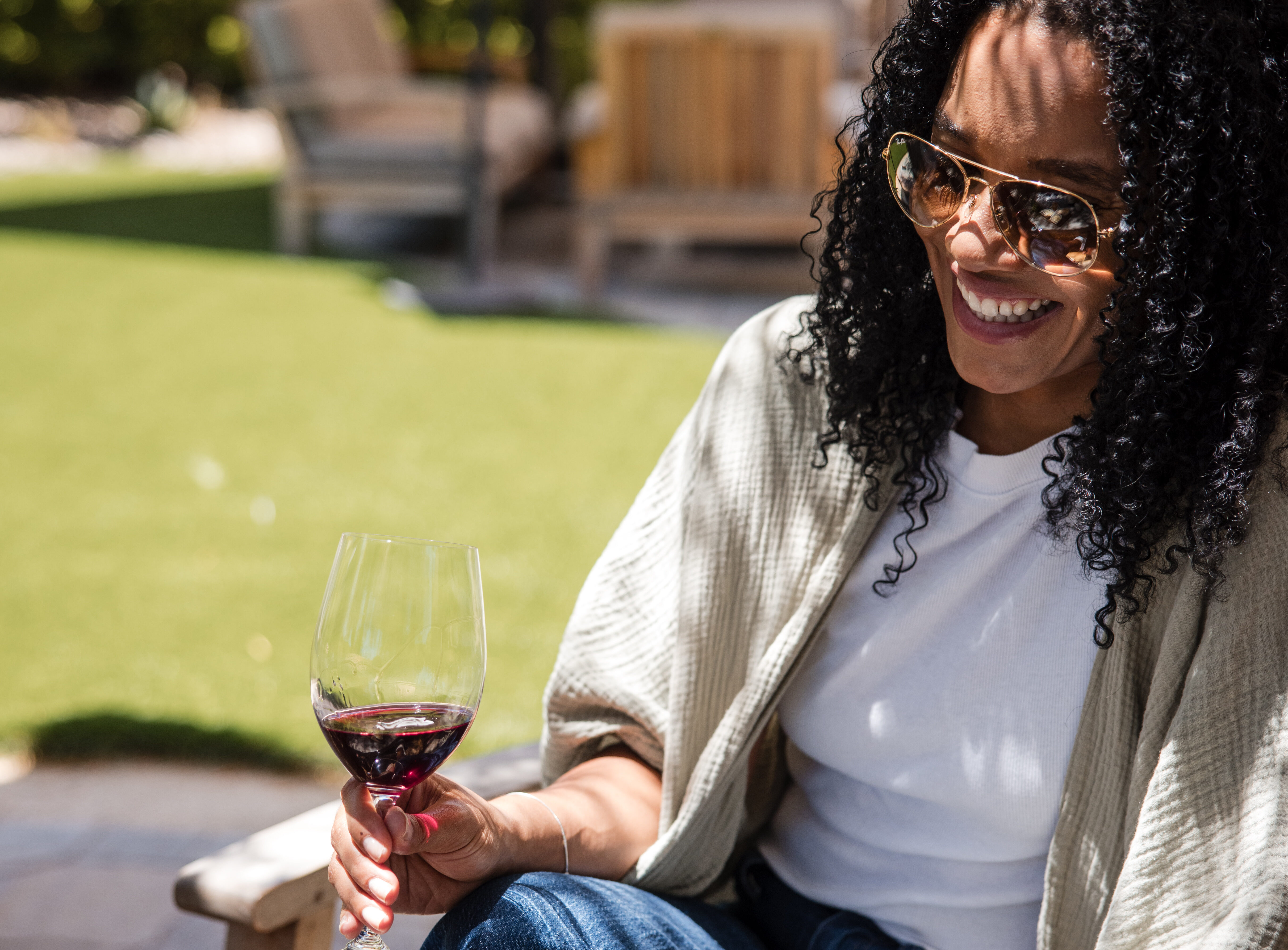 Person smiling with wine glass